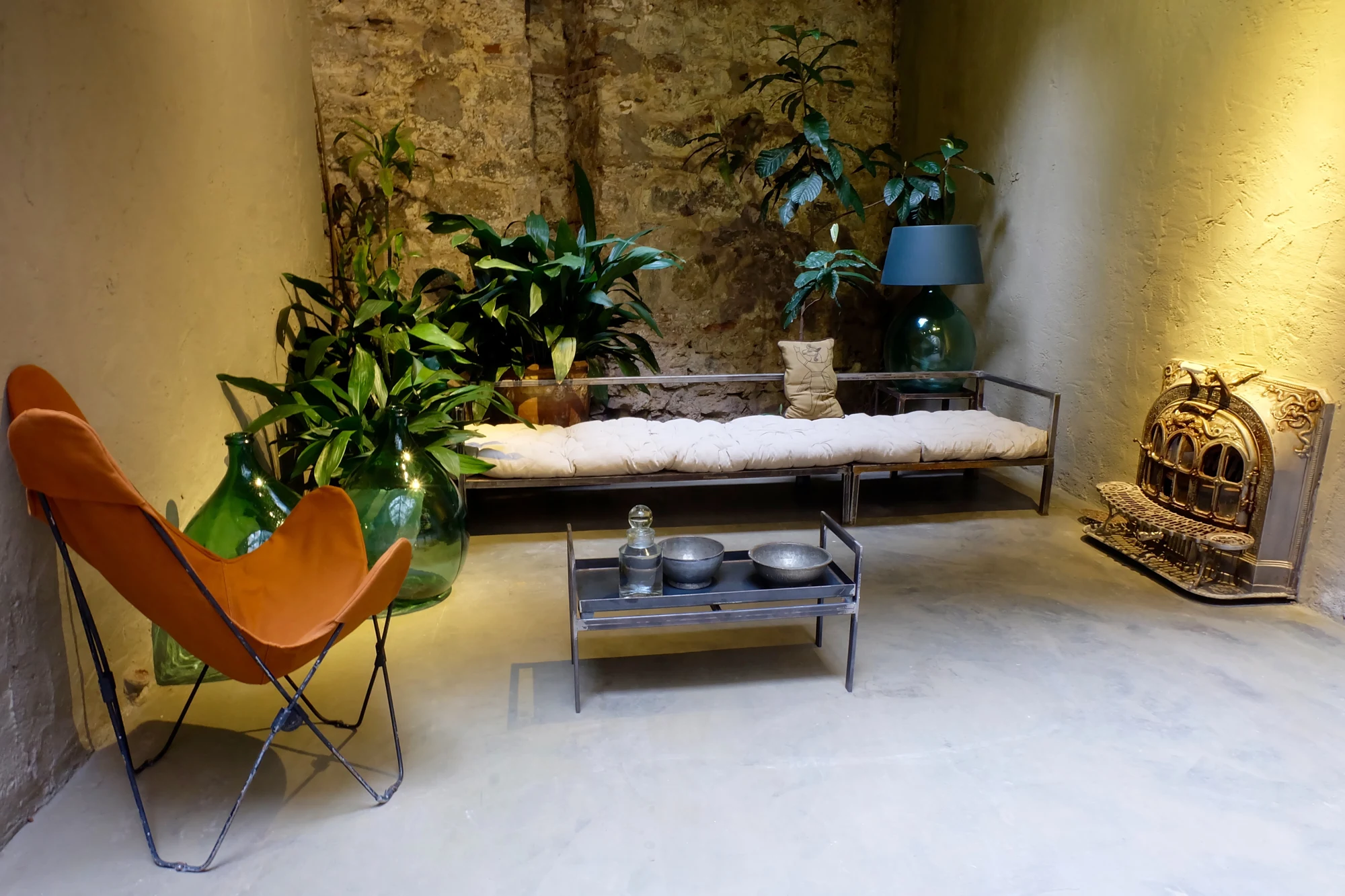 The atelier seating area with textured walls, plants and furniture